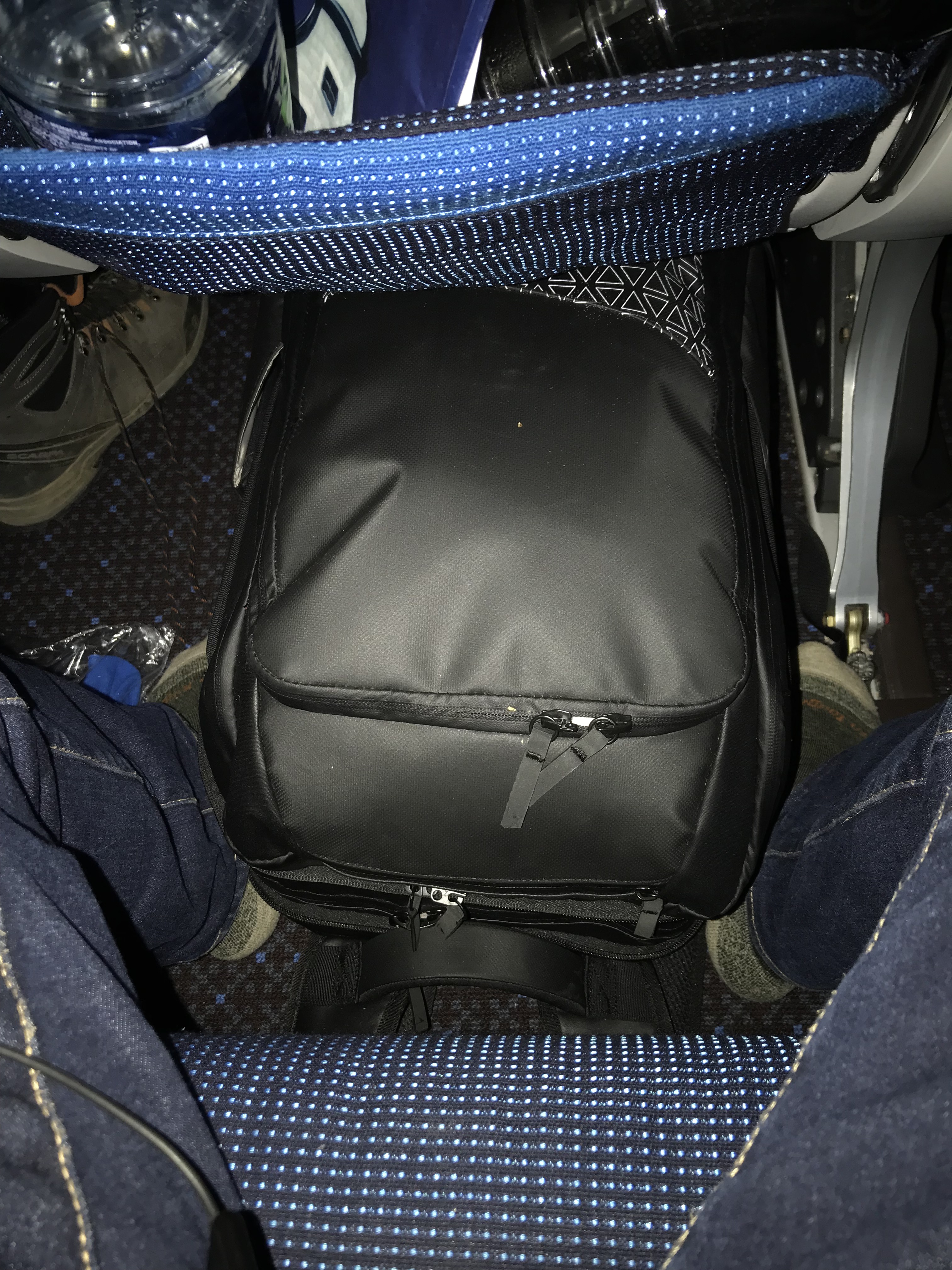 backpack under airplane seat